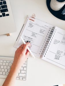 person scheduling check ins on a planner