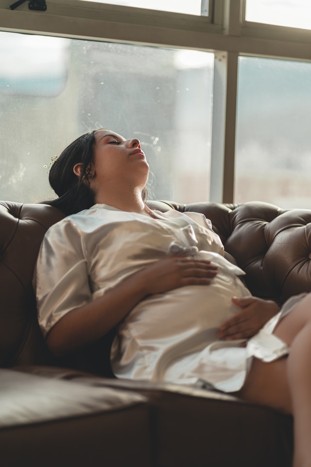 A woman feeling her pregnant belly