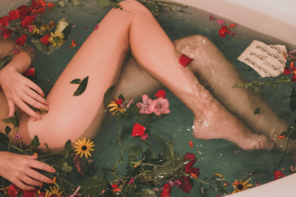 A woman in a bathtub with flowers