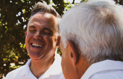 two older men laughing