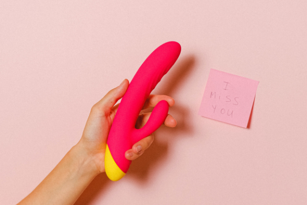 hand holding a pink vibrator
