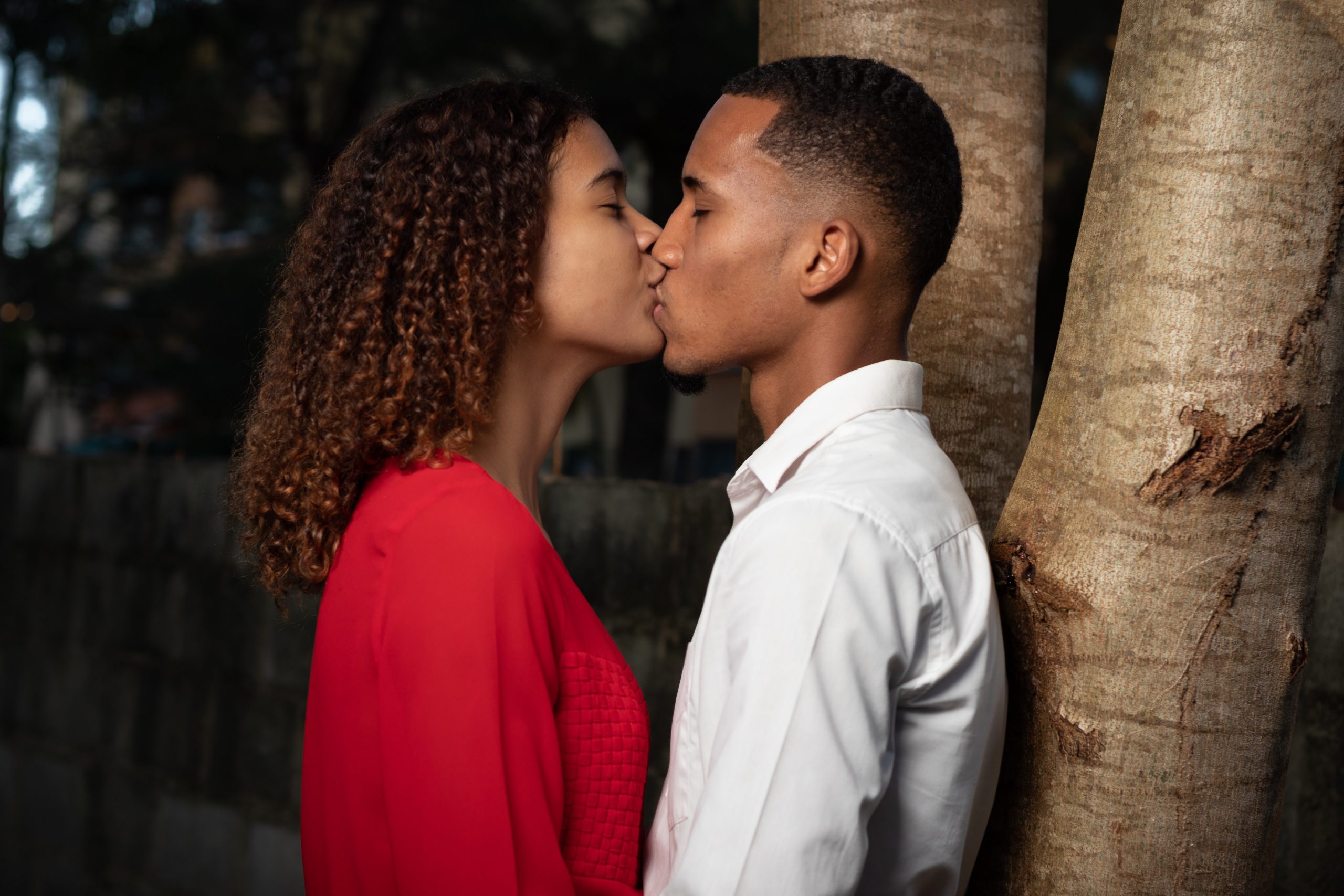 a man and a woman share a kiss