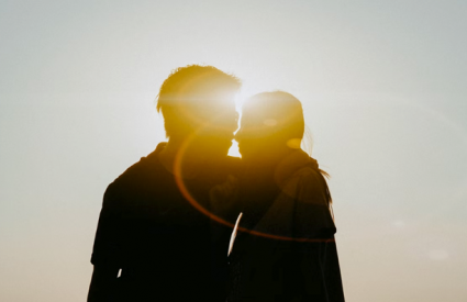 a couple embraces at sunset