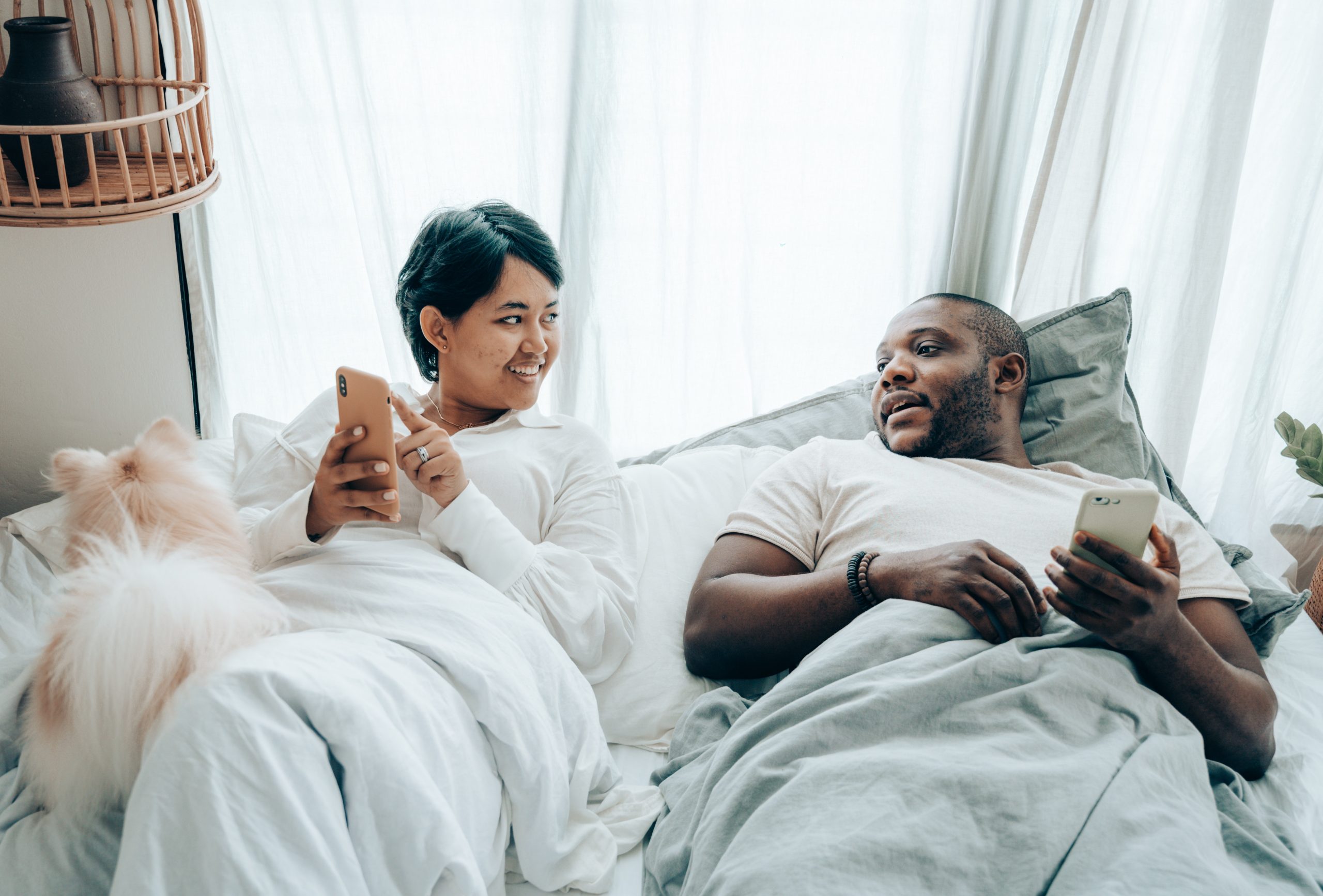 a man and a woman talk in bed