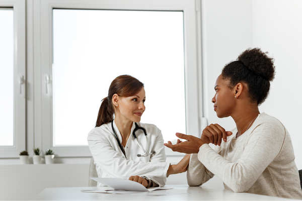 a patient speaks with her doctor about STIs