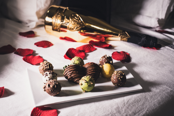 Rose petals and chocolate covered strawberries
